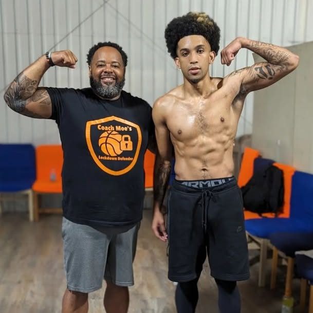 Coach Moe and one of his athletes flexing after a workout